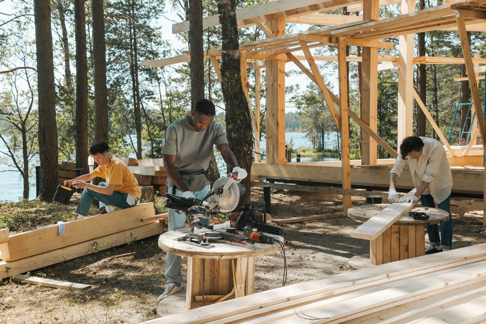 Crew building a timber frame home outdoors